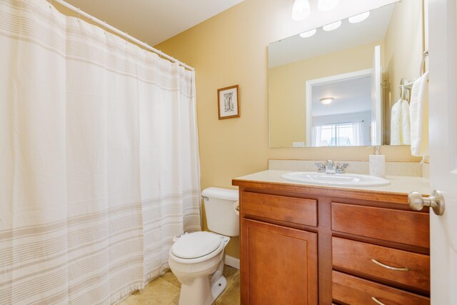 bathroom featuring toilet, vanity, and tile patterned floors