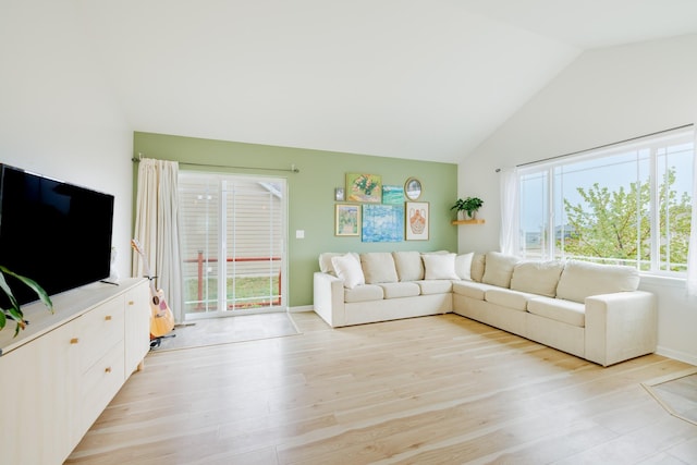 living room with light wood finished floors and lofted ceiling