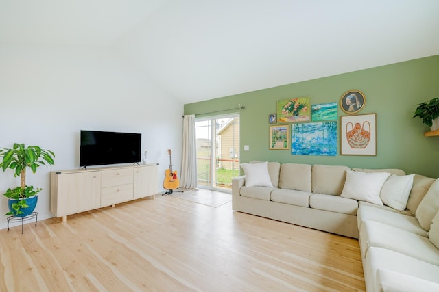 living room featuring wood finished floors and vaulted ceiling