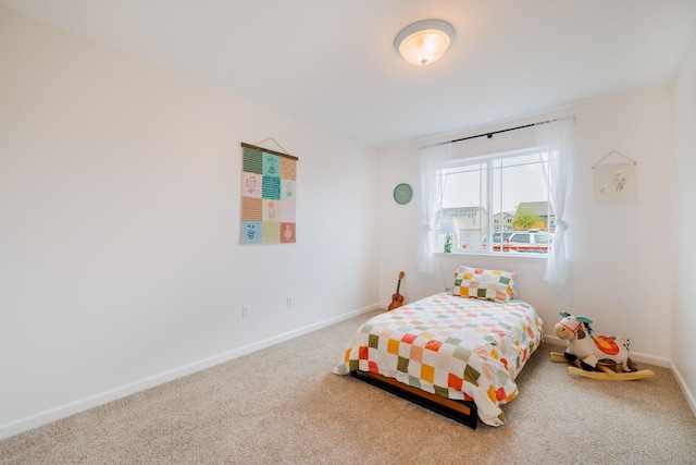 bedroom featuring carpet and baseboards