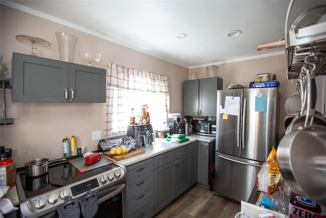 1011 4th Ave NW, Great Falls, MT 59404 - kitchen featuring appliances with stainless steel finishes, gray cabinets, light countertops, dark wood-style flooring, and crown molding