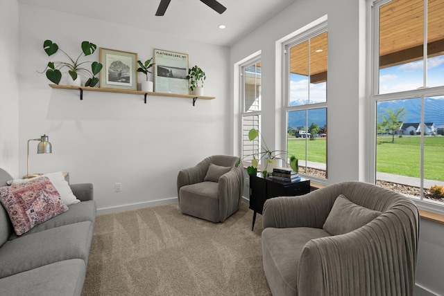 carpeted living area featuring healthy amount of natural light, a ceiling fan, recessed lighting, and baseboards