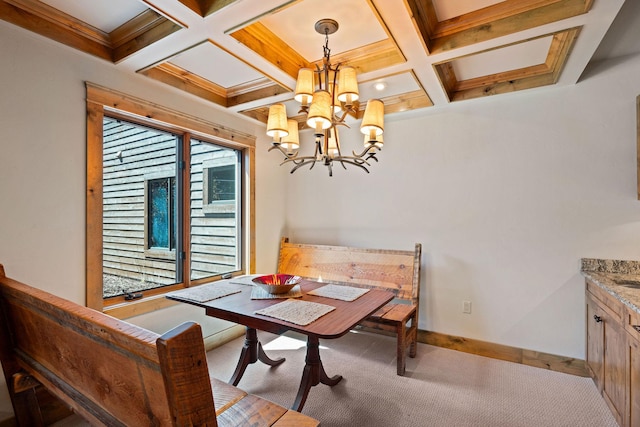 carpeted dining space with a chandelier, beamed ceiling, coffered ceiling, and baseboards