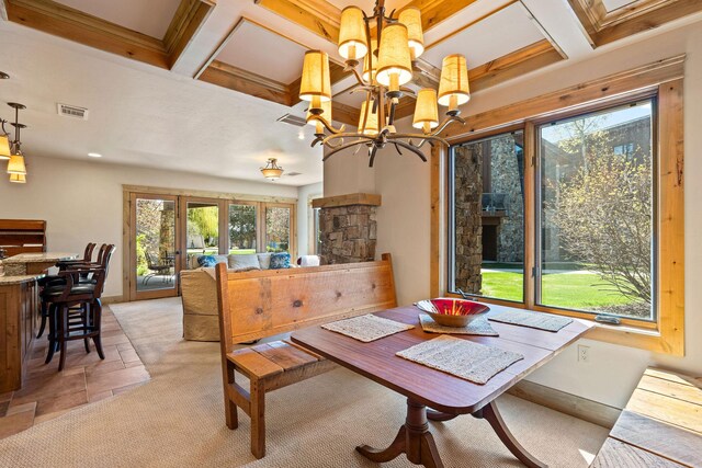 dining area featuring coffered ceiling, plenty of natural light, a chandelier, beam ceiling, and light carpet