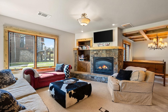 living area featuring a chandelier, carpet flooring, coffered ceiling, recessed lighting, and a stone fireplace