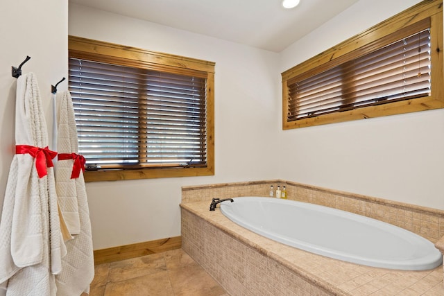 full bathroom with a garden tub, baseboards, tile patterned flooring, and recessed lighting