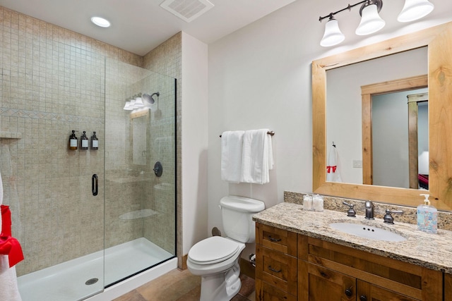 full bath featuring a shower stall, toilet, and vanity