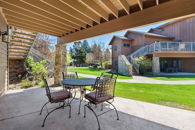 view of patio with stairs and outdoor dining area