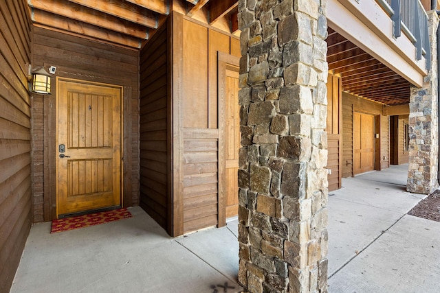 doorway to property with stone siding