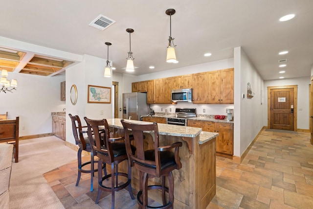 kitchen with stainless steel appliances, recessed lighting, baseboards, a breakfast bar area, and brown cabinets