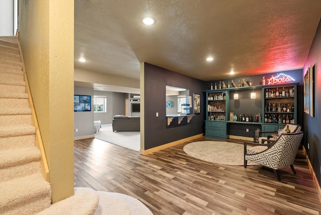 58 Morning View Way, Kalispell, MT 59901 - indoor dry bar featuring stairs, wood finished floors, recessed lighting, a textured ceiling, and baseboards