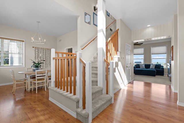 58 Morning View Way, Kalispell, MT 59901 - staircase with wood finished floors, a chandelier, and baseboards