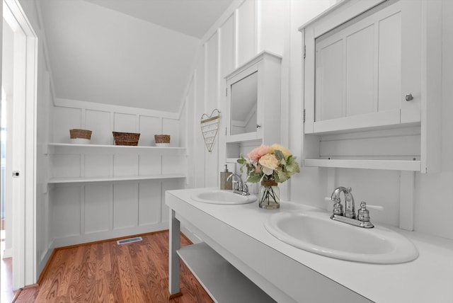 58 Morning View Way, Kalispell, MT 59901 - bathroom featuring wood finished floors, double vanity, and lofted ceiling