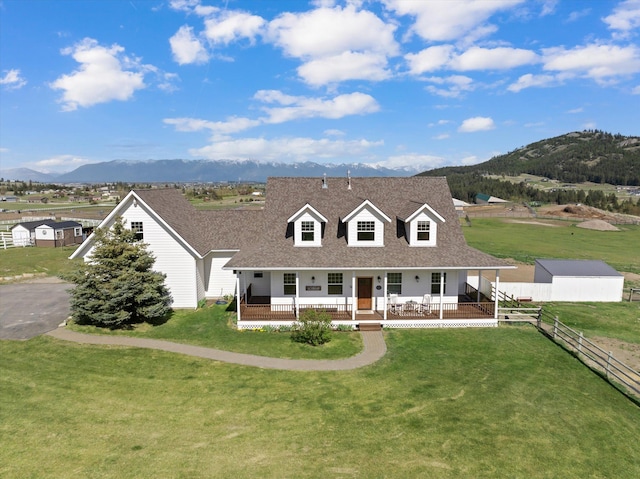 58 Morning View Way, Kalispell, MT 59901 - view of front of home with a mountain view, a porch, roof with shingles, and an outbuilding
