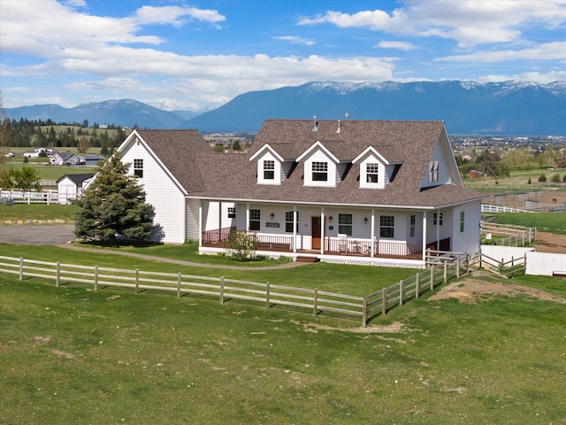 58 Morning View Way, Kalispell, MT 59901 - cape cod-style house with a mountain view, a porch, a view of countryside, and a shingled roof