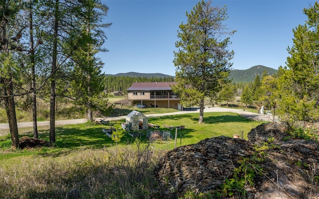 5550 Farm To Market Rd, Whitefish, MT 59937 - view of grassy yard featuring a deck with mountain view