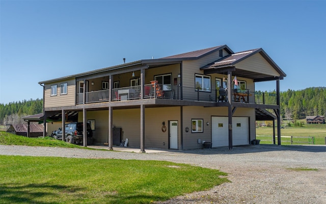 5550 Farm To Market Rd, Whitefish, MT 59937 - rear view of property featuring driveway, an attached garage, and a yard