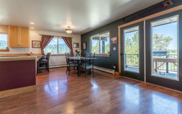 5550 Farm To Market Rd, Whitefish, MT 59937 - dining space with a baseboard radiator, wood finished floors, recessed lighting, and baseboards