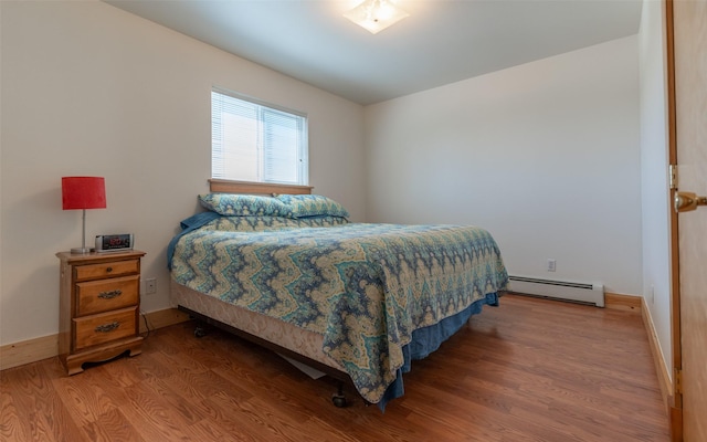 5550 Farm To Market Rd, Whitefish, MT 59937 - bedroom featuring a baseboard radiator, wood finished floors, and baseboards