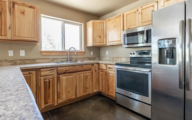 5550 Farm To Market Rd, Whitefish, MT 59937 - kitchen featuring stainless steel appliances, a sink, light countertops, light brown cabinets, and concrete floors