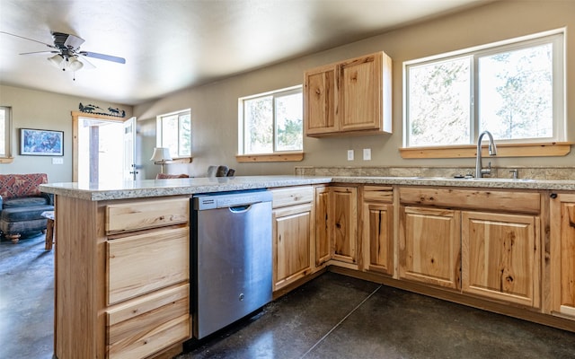 5550 Farm To Market Rd, Whitefish, MT 59937 - kitchen featuring stainless steel dishwasher, a sink, finished concrete flooring, a peninsula, and light countertops