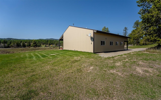 5550 Farm To Market Rd, Whitefish, MT 59937 - view of property exterior featuring a lawn, an outdoor structure, and a pole building