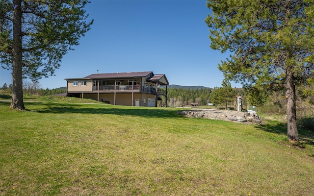 5550 Farm To Market Rd, Whitefish, MT 59937 - view of green lawn featuring a deck with mountain view