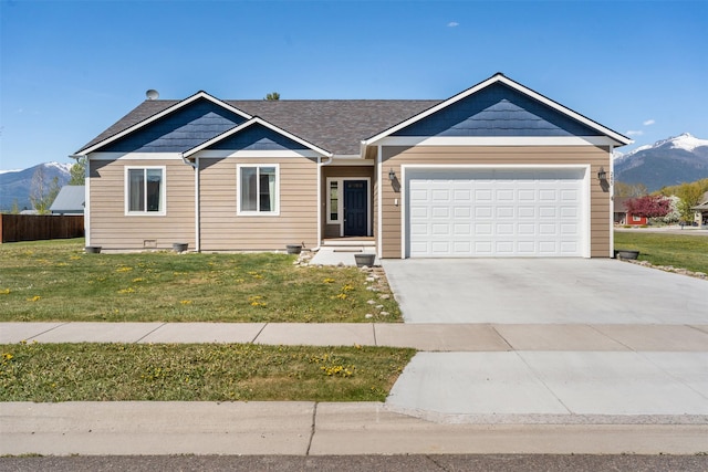 view of front facade featuring a mountain view, a garage, and driveway