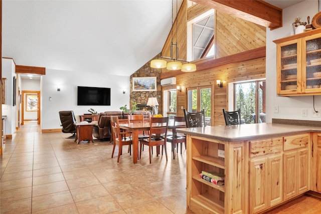 dining room featuring high vaulted ceiling, wood walls, a wall mounted air conditioner, and light tile patterned floors