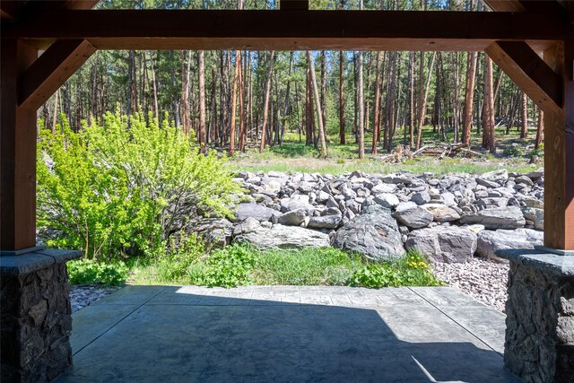 view of patio / terrace featuring a wooded view