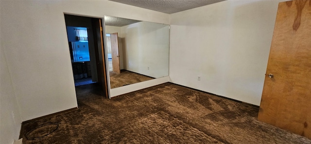 11169 Stemple Pass Rd, Lincoln, MT 59639 - spare room featuring carpet floors, a textured ceiling, and baseboards
