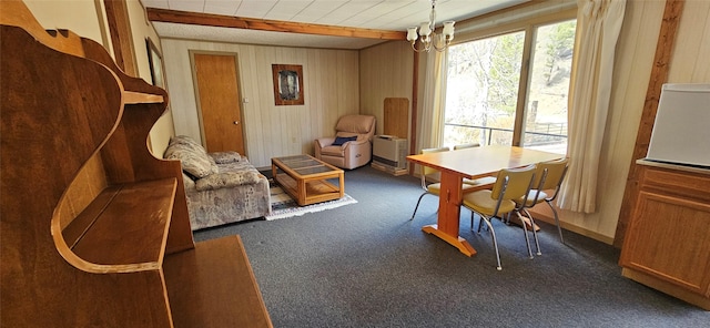 11169 Stemple Pass Rd, Lincoln, MT 59639 - dining room featuring carpet floors, a chandelier, and wooden walls