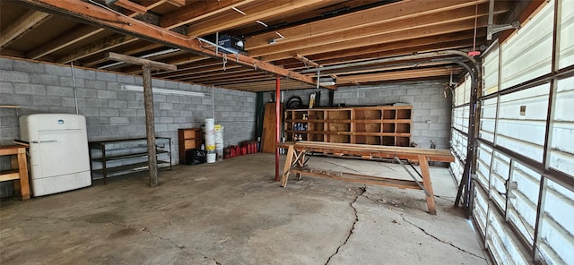 11169 Stemple Pass Rd, Lincoln, MT 59639 - below grade area featuring freestanding refrigerator and concrete block wall