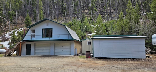 11169 Stemple Pass Rd, Lincoln, MT 59639 - garage with a forest view and a storage shed