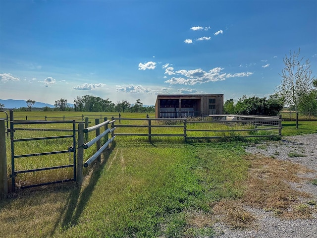 308 Dupuyer Creek Rd, Dupuyer, MT 59432 - view of yard featuring an outbuilding, a garage, a rural view, and an exterior structure