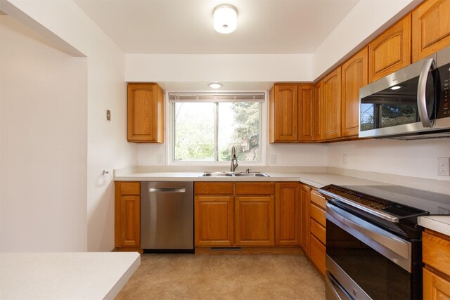 433 N 10th Ave, Bozeman, MT 59715 - kitchen with appliances with stainless steel finishes, a sink, light countertops, and brown cabinets