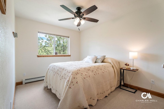bedroom with a baseboard heating unit, light carpet, baseboards, and ceiling fan