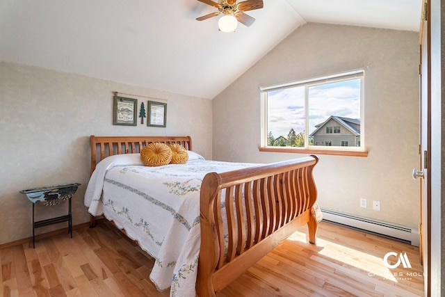 bedroom with a baseboard heating unit, wood finished floors, lofted ceiling, and a ceiling fan