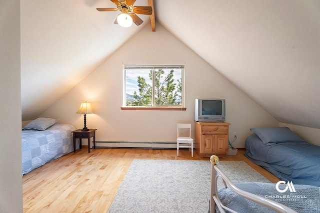 bedroom featuring baseboard heating, wood finished floors, and a ceiling fan