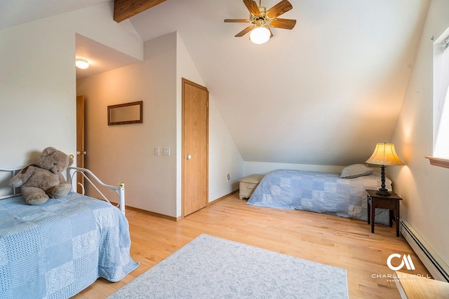 bedroom with baseboard heating, light wood finished floors, baseboards, and ceiling fan