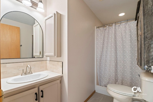 full bathroom with backsplash, toilet, vanity, tile patterned floors, and curtained shower