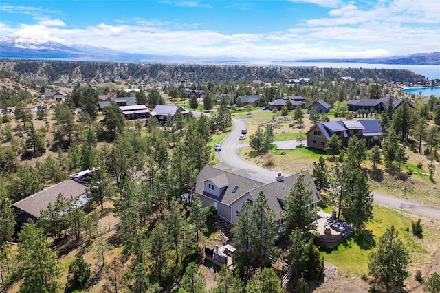 aerial view of residential area featuring a water and mountain view