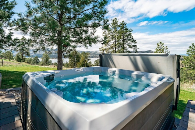 view of pool with a hot tub