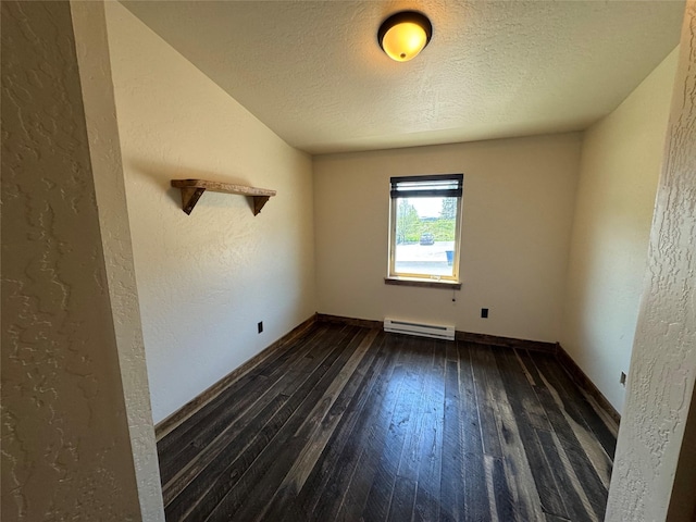 empty room with a baseboard heating unit, dark wood finished floors, a textured ceiling, a textured wall, and baseboards