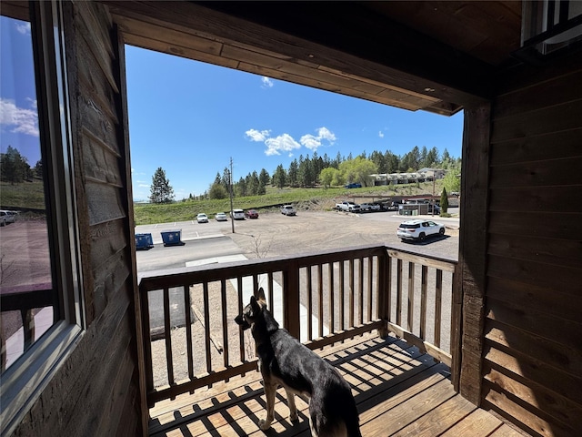wooden deck with view of scattered trees