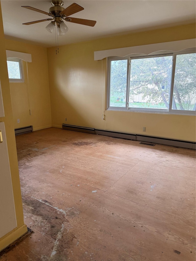 empty room with baseboard heating, a ceiling fan, and a baseboard heating unit