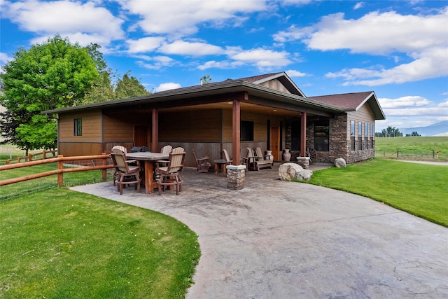 45292 Locust Ln, Charlo, MT 59824 - rear view of house featuring a patio area and stone siding