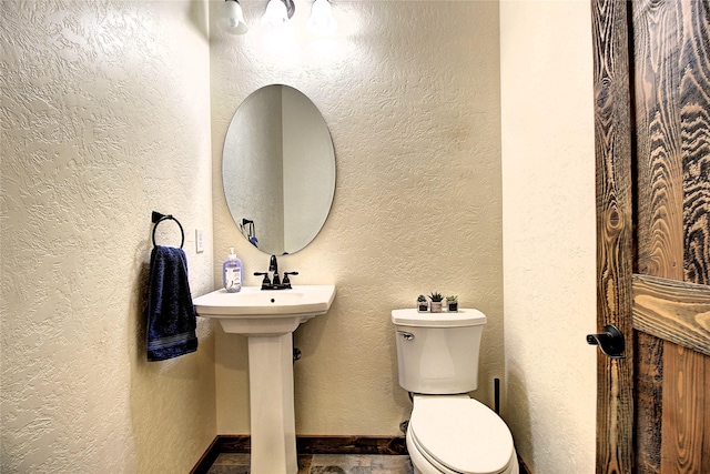 45292 Locust Ln, Charlo, MT 59824 - half bath with toilet, baseboards, and a textured wall