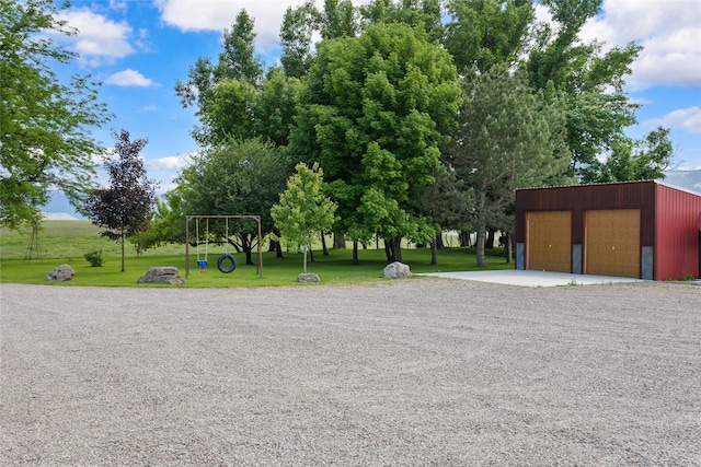 45292 Locust Ln, Charlo, MT 59824 - view of home's community with a detached garage, an outbuilding, and a lawn