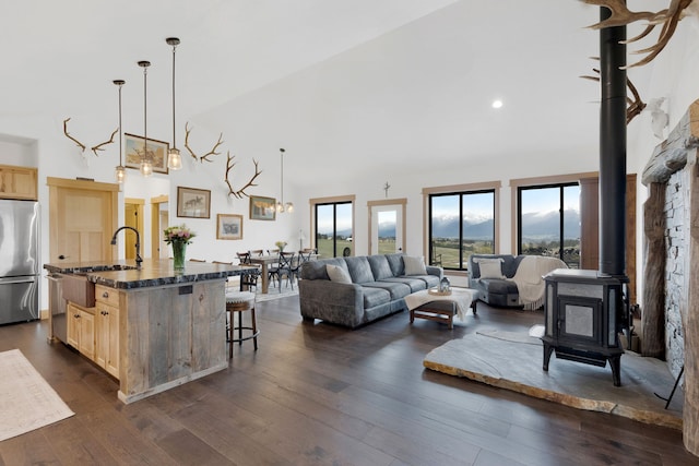 559 Stage Springs Ln, Stevensville, MT 59870 - living area with a wood stove, dark wood-style floors, high vaulted ceiling, and recessed lighting